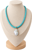 A turquoise beaded necklace with a large white baroque pearl pendant, displayed on a beige fabric jewelry bust against a white background.